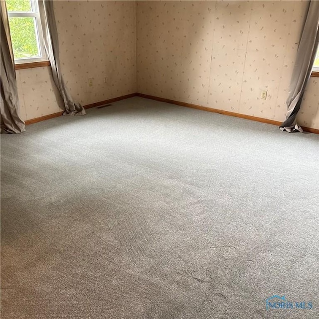 404 E Garfield Ave, Swanton, OH 43558 - unfurnished room featuring carpet floors and wallpapered walls