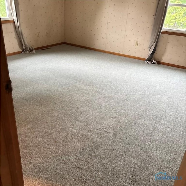 404 E Garfield Ave, Swanton, OH 43558 - carpeted empty room with wallpapered walls and baseboards