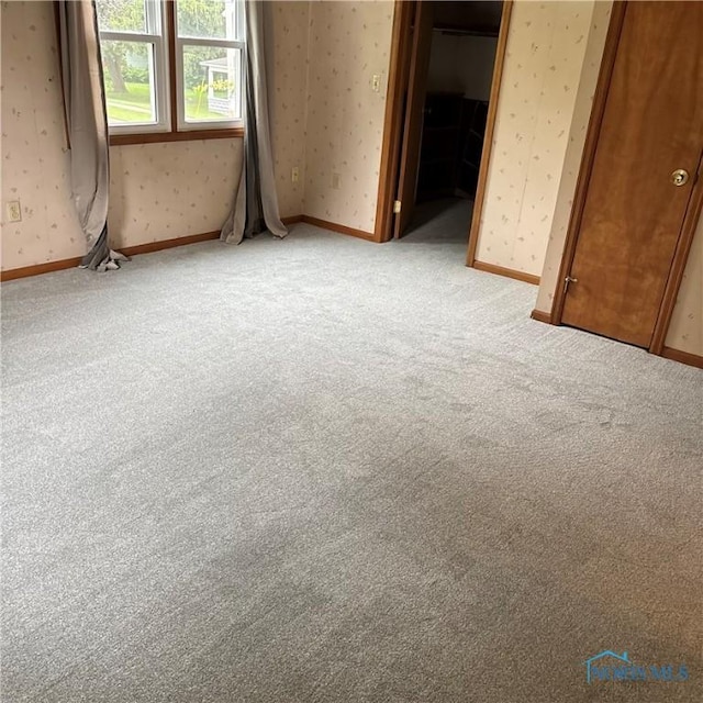 404 E Garfield Ave, Swanton, OH 43558 - unfurnished room with wallpapered walls and carpet