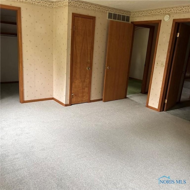 404 E Garfield Ave, Swanton, OH 43558 - unfurnished bedroom with wallpapered walls and carpet
