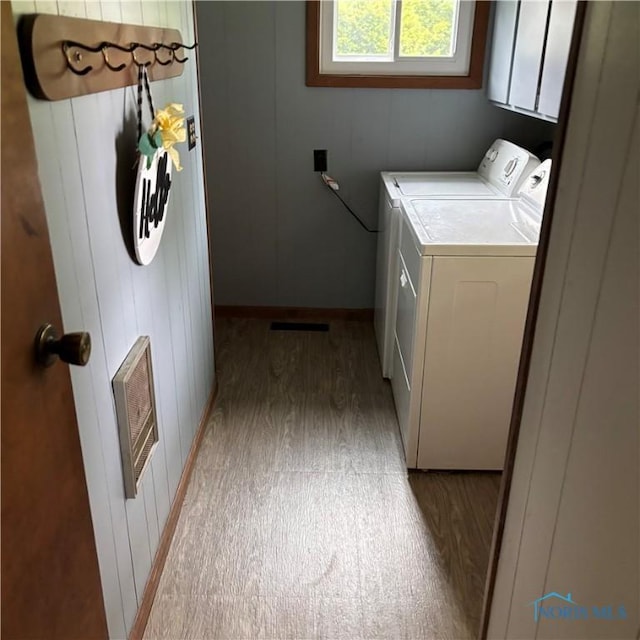 404 E Garfield Ave, Swanton, OH 43558 - washroom with washing machine and clothes dryer, cabinet space, and light wood finished floors
