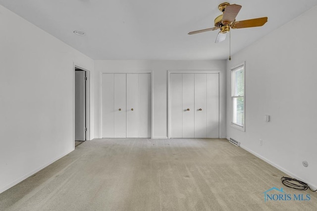 3733 Shamrock Dr, Toledo, OH 43615 - unfurnished bedroom with multiple closets, carpet floors, and ceiling fan