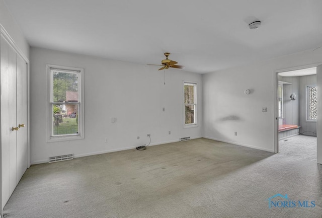 3733 Shamrock Dr, Toledo, OH 43615 - empty room featuring healthy amount of natural light, a ceiling fan, and carpet floors