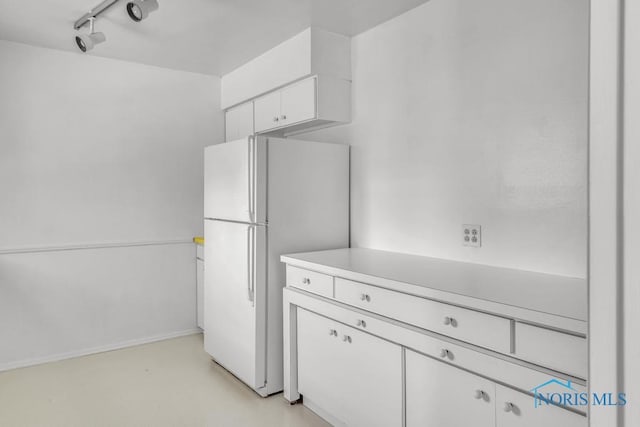 3733 Shamrock Dr, Toledo, OH 43615 - kitchen featuring freestanding refrigerator, white cabinetry, light countertops, and track lighting