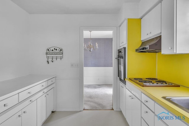 3733 Shamrock Dr, Toledo, OH 43615 - kitchen featuring under cabinet range hood, electric stovetop, stainless steel oven, and white cabinets