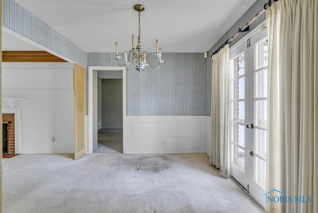 3733 Shamrock Dr, Toledo, OH 43615 - unfurnished dining area featuring wallpapered walls, a chandelier, and carpet flooring