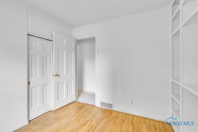 3733 Shamrock Dr, Toledo, OH 43615 - unfurnished bedroom with light wood finished floors and baseboards
