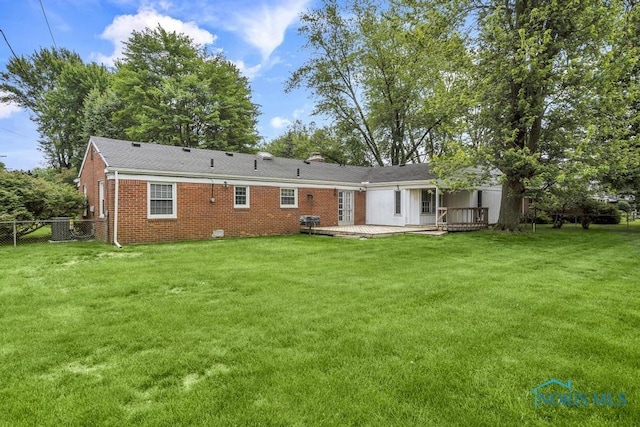 3733 Shamrock Dr, Toledo, OH 43615 - back of house with brick siding, a chimney, and a wooden deck