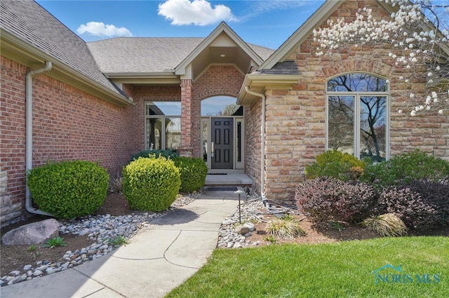 3862 Ravine Hollow Ct, Maumee, OH 43537 - property entrance featuring roof with shingles, brick siding, and stone siding