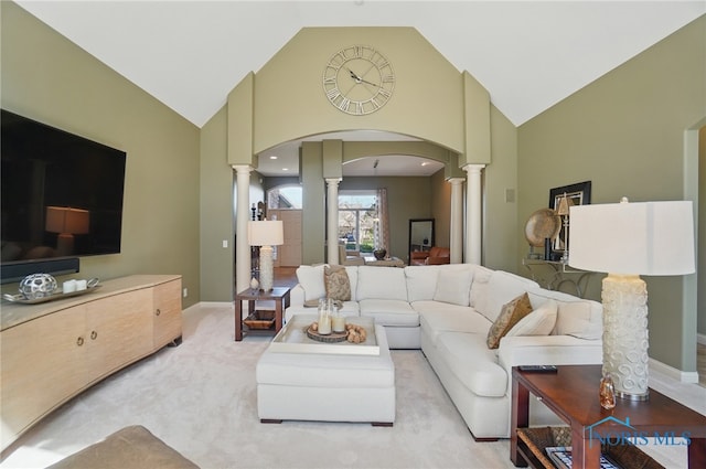 3862 Ravine Hollow Ct, Maumee, OH 43537 - living area featuring ornate columns, high vaulted ceiling, arched walkways, and light colored carpet