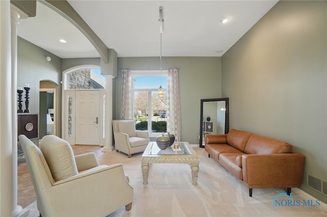 3862 Ravine Hollow Ct, Maumee, OH 43537 - living room featuring arched walkways, ornate columns, and recessed lighting