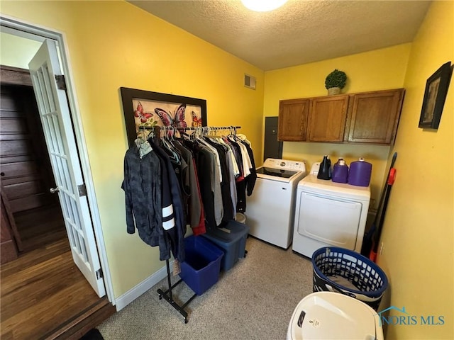 506 Ditto St, Archbold, OH 43502 - laundry area featuring independent washer and dryer, cabinet space, a textured ceiling, and electric panel