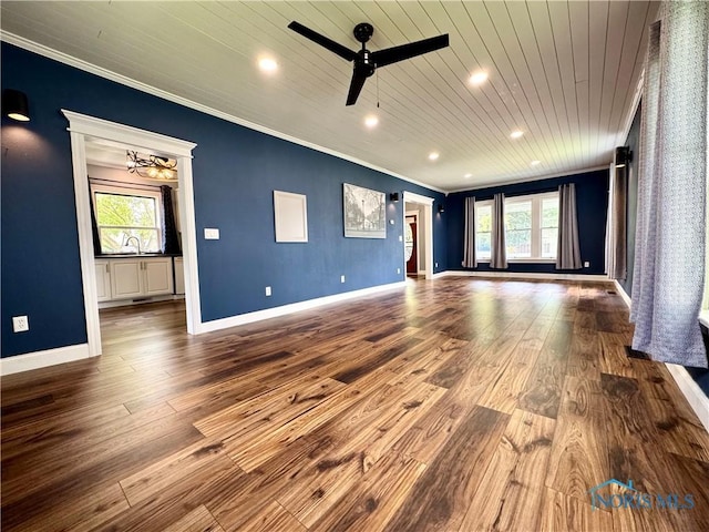 716 Davidson St, Defiance, OH 43512 - unfurnished living room featuring crown molding, plenty of natural light, dark wood-type flooring, wood ceiling, and a ceiling fan