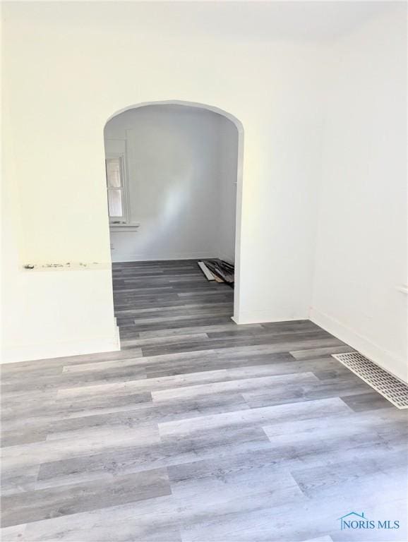 1817 Ridgewood Ave, Toledo, OH 43608 - spare room featuring arched walkways and wood finished floors