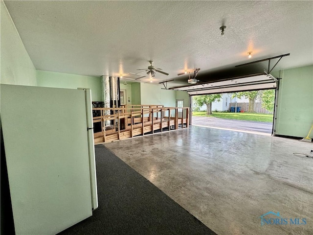 220 Rolland St, Bryan, OH 43506 - garage featuring freestanding refrigerator and ceiling fan