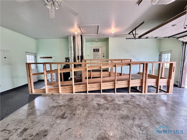 220 Rolland St, Bryan, OH 43506 - garage featuring electric panel and a ceiling fan
