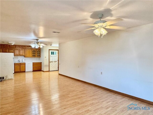 220 Rolland St, Bryan, OH 43506 - unfurnished living room featuring ceiling fan and light wood finished floors