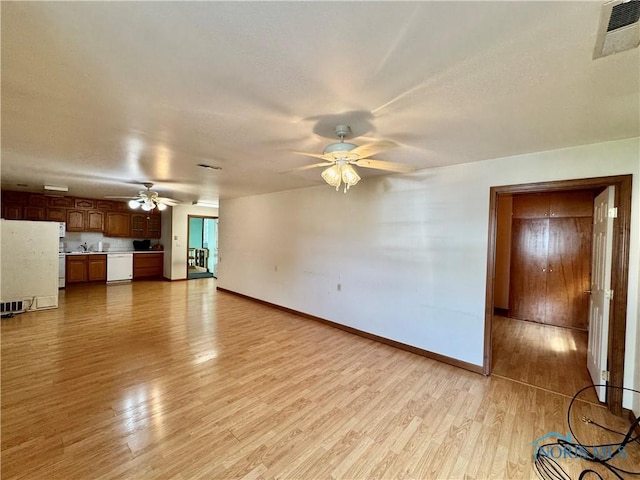 220 Rolland St, Bryan, OH 43506 - unfurnished living room featuring a ceiling fan and light wood-style flooring