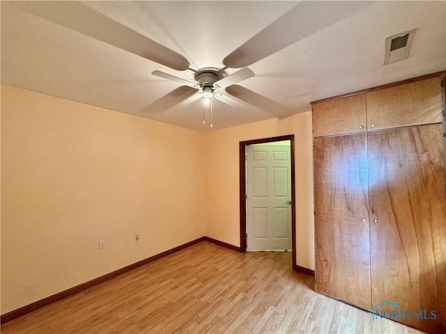 220 Rolland St, Bryan, OH 43506 - unfurnished bedroom featuring light wood-style floors and a ceiling fan