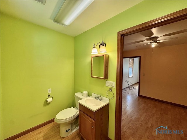 220 Rolland St, Bryan, OH 43506 - bathroom with wood finished floors, vanity, and ceiling fan