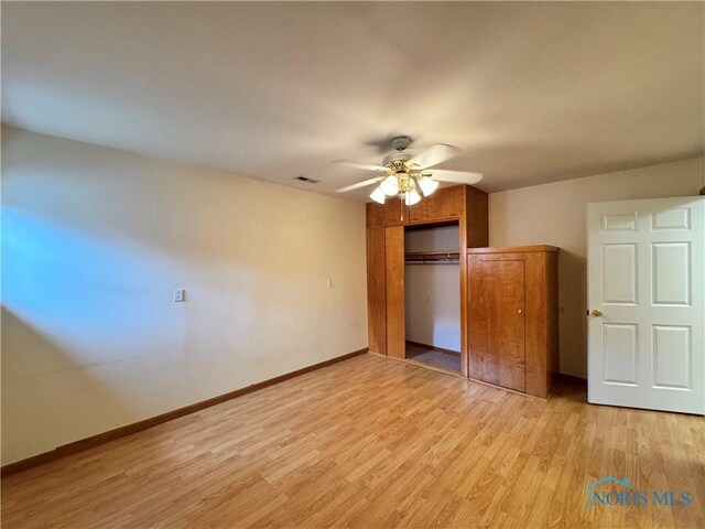 220 Rolland St, Bryan, OH 43506 - unfurnished bedroom featuring light wood finished floors, a closet, and a ceiling fan