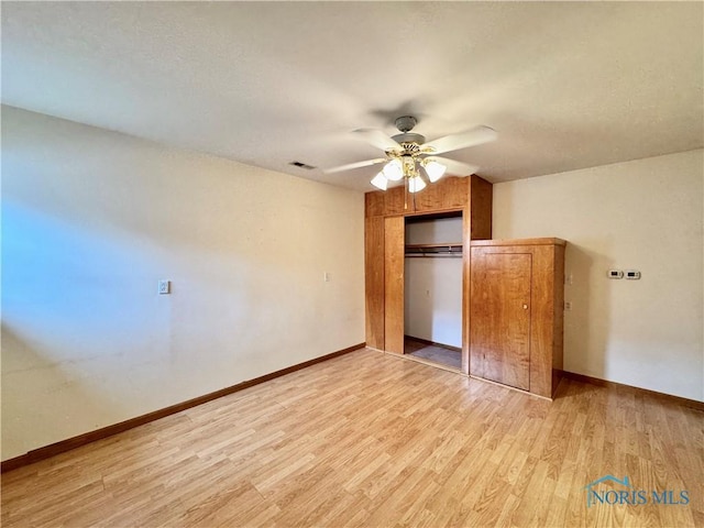 220 Rolland St, Bryan, OH 43506 - unfurnished bedroom with light wood-style flooring, a closet, a ceiling fan, and a textured ceiling