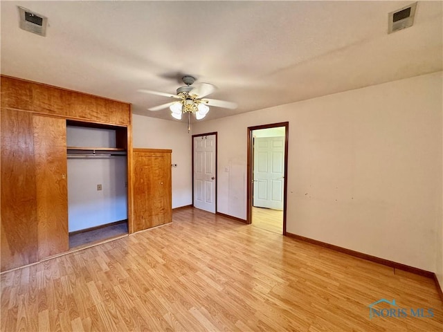 220 Rolland St, Bryan, OH 43506 - unfurnished bedroom with light wood-style flooring, a closet, and a ceiling fan