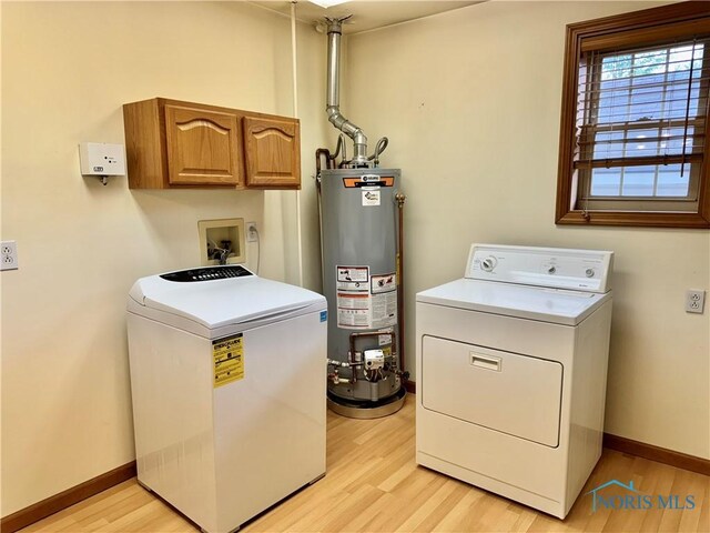 220 Rolland St, Bryan, OH 43506 - laundry area featuring gas water heater, independent washer and dryer, light wood-type flooring, and cabinet space