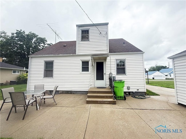 703 College Ave, Fostoria, OH 44830 - back of house featuring a patio and a shingled roof
