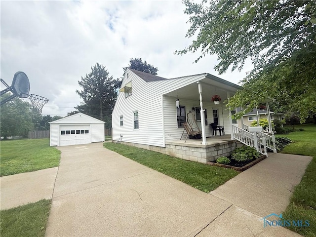 703 College Ave, Fostoria, OH 44830 - view of home's exterior with a porch, concrete driveway, a lawn, and an outbuilding