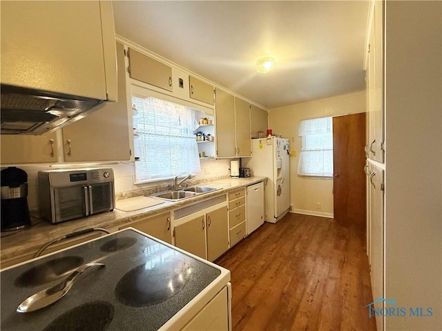 703 College Ave, Fostoria, OH 44830 - kitchen with white appliances, wood finished floors, healthy amount of natural light, and ornamental molding