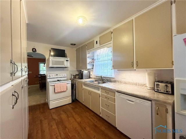 703 College Ave, Fostoria, OH 44830 - kitchen with white appliances, dark wood finished floors, light countertops, backsplash, and crown molding