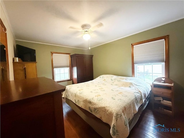 703 College Ave, Fostoria, OH 44830 - bedroom with dark wood finished floors, crown molding, and ceiling fan