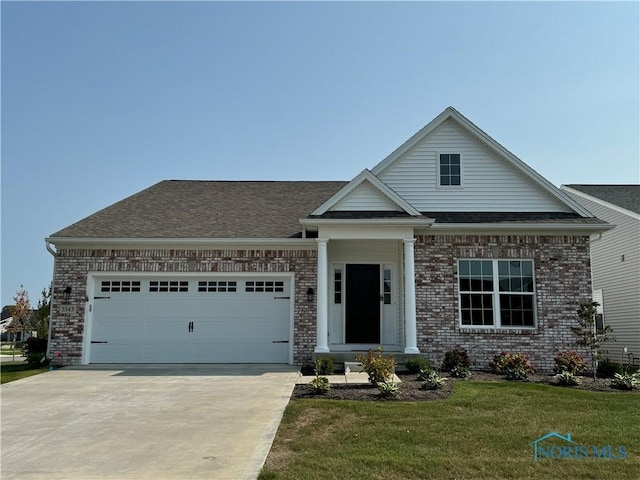 3343 Moonlit Pass, Monclova, OH 43542 - view of front of house featuring brick siding, driveway, an attached garage, a front yard, and roof with shingles