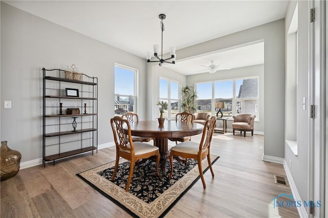 3343 Moonlit Pass, Monclova, OH 43542 - dining area featuring light wood-style flooring, a chandelier, and ceiling fan