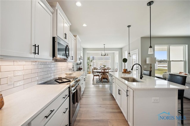3343 Moonlit Pass, Monclova, OH 43542 - kitchen with stainless steel appliances, healthy amount of natural light, backsplash, white cabinets, and recessed lighting