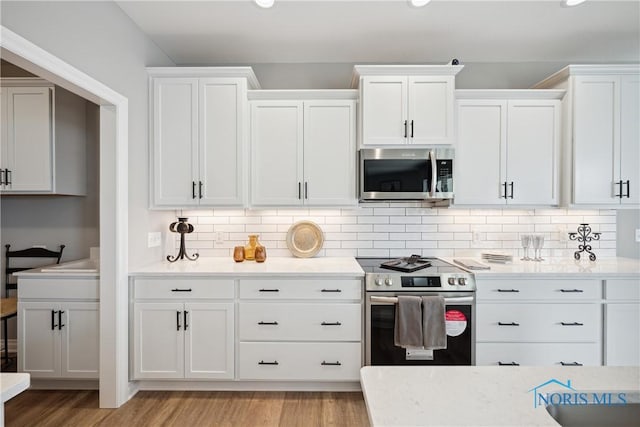 3343 Moonlit Pass, Monclova, OH 43542 - kitchen featuring stainless steel appliances, white cabinets, light wood-type flooring, and recessed lighting