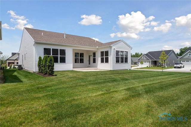 3343 Moonlit Pass, Monclova, OH 43542 - back of property with a yard and a patio area