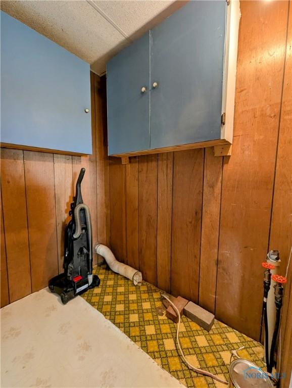 6151 The Bend Rd, Ney, OH 43549 - unfurnished bedroom featuring wood walls and tile patterned floors