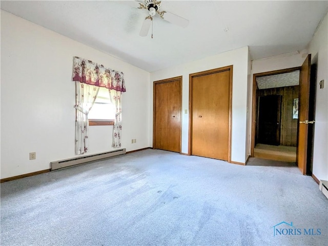 6151 The Bend Rd, Ney, OH 43549 - unfurnished bedroom with a baseboard heating unit, two closets, light colored carpet, and a ceiling fan