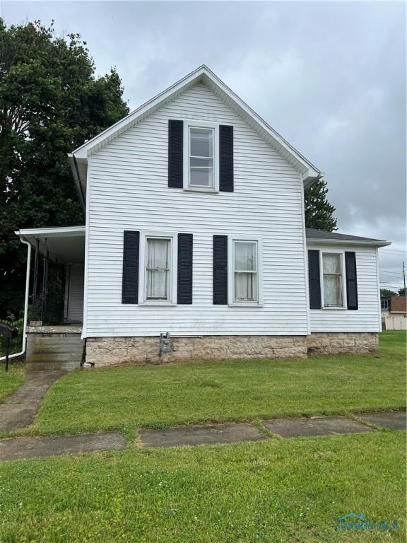 643 N 5th St, Fremont, OH 43420 - view of side of home with a lawn and a porch