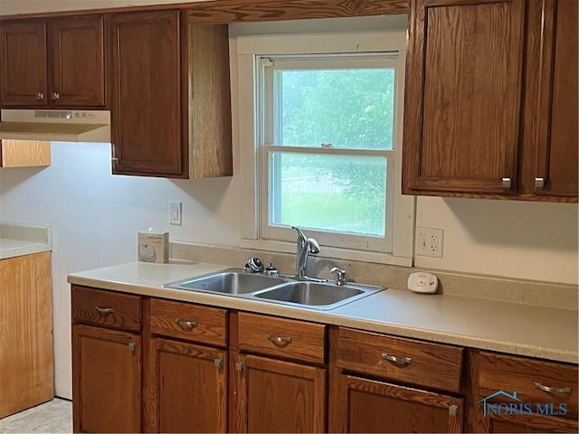 643 N 5th St, Fremont, OH 43420 - kitchen with under cabinet range hood, light countertops, and healthy amount of natural light
