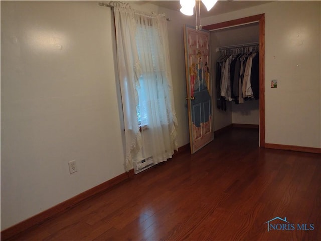 200 Pleasant St, Archbold, OH 43502 - unfurnished bedroom with dark wood-style floors and a closet