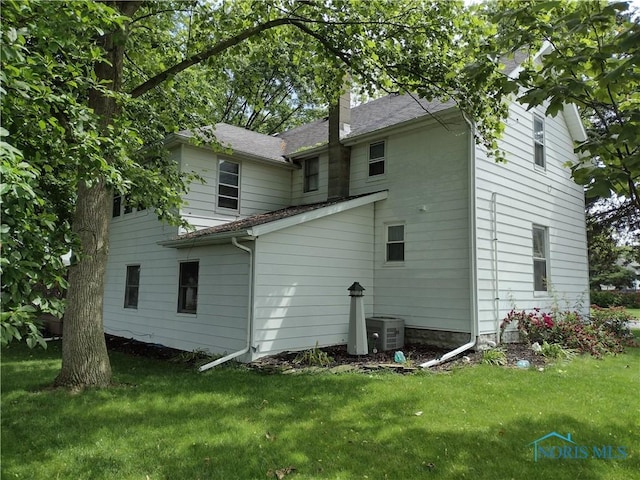 200 Pleasant St, Archbold, OH 43502 - back of property featuring a chimney, a yard, and a shingled roof