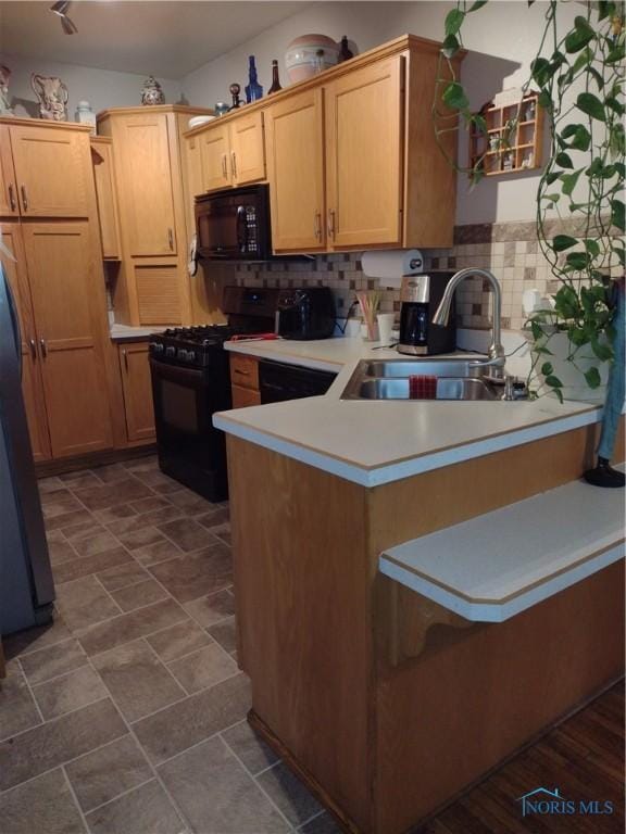 200 Pleasant St, Archbold, OH 43502 - kitchen with black appliances, backsplash, a peninsula, and light countertops