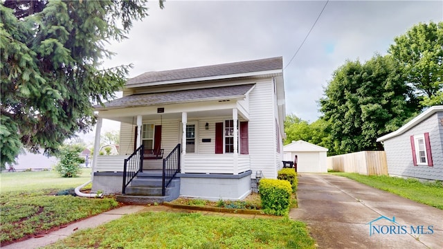 420 Ames St, Clyde, OH 43410 - view of front facade featuring an outdoor structure, a porch, a garage, and roof with shingles