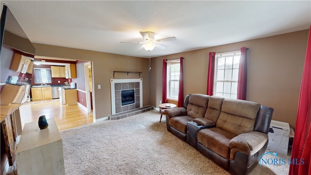 420 Ames St, Clyde, OH 43410 - living area with ceiling fan, light carpet, and a fireplace