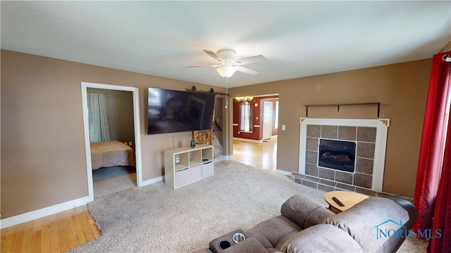 420 Ames St, Clyde, OH 43410 - living area with ceiling fan, a tiled fireplace, and carpet flooring