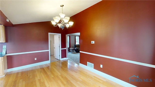 420 Ames St, Clyde, OH 43410 - unfurnished dining area featuring a chandelier, light wood-type flooring, and high vaulted ceiling