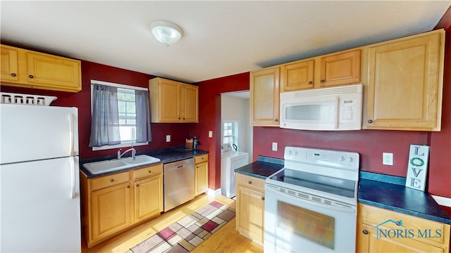 420 Ames St, Clyde, OH 43410 - kitchen with white appliances, dark countertops, and light brown cabinetry